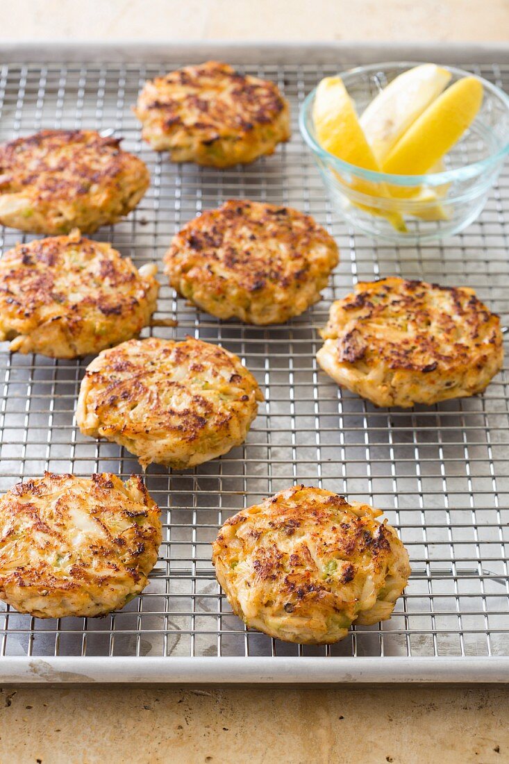 Crab cakes on a cooling rack on a baking tray