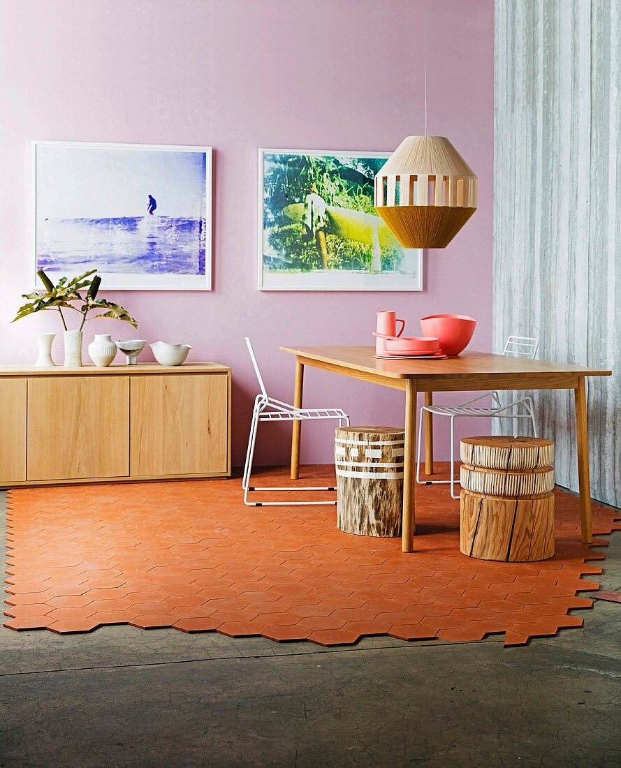 Partially laid terracotta floor in the dining room with a pink wall