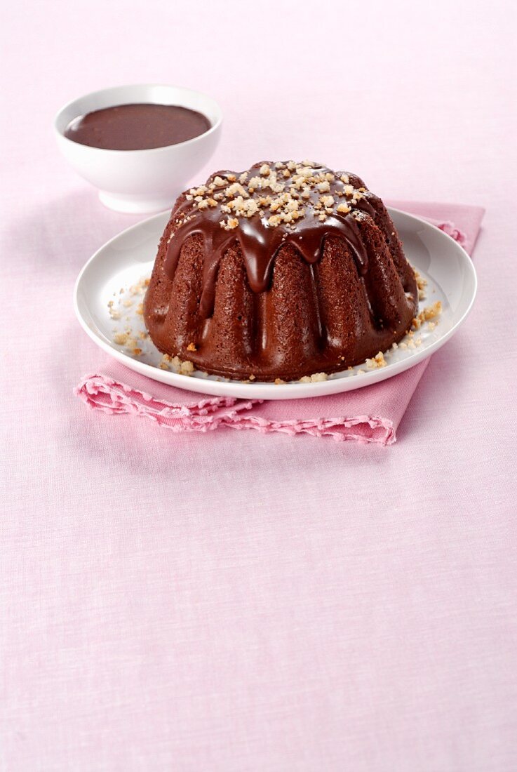 Chocolate pudding with chocolate sauce and Amaretti crumbs