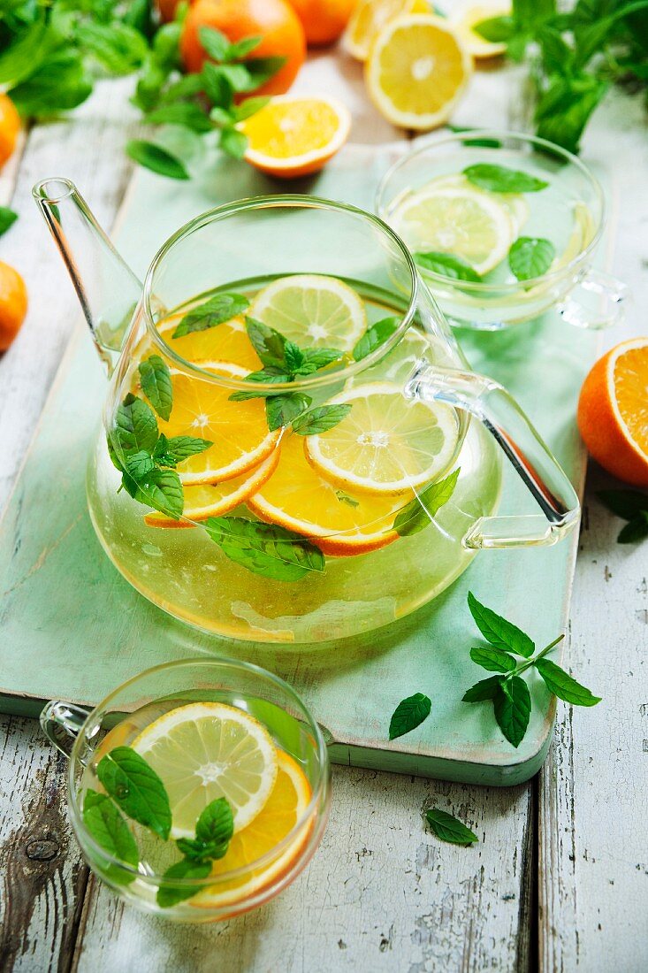 Citrus fruit tea with mint in a glass jug