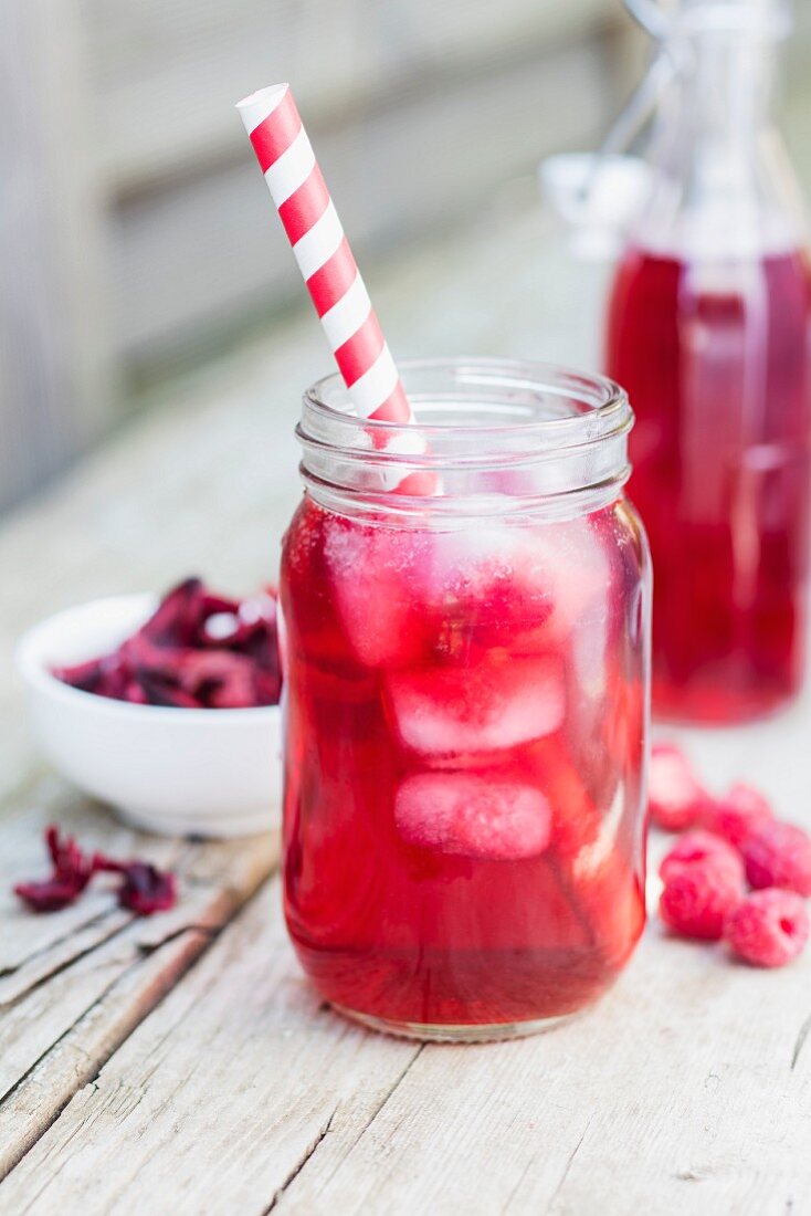 Tea lemonade with hibiscus flowers and raspberries