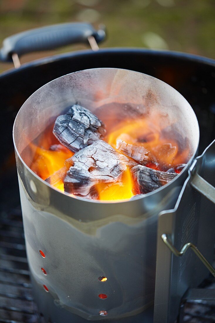 A chimney starter on a barbecue