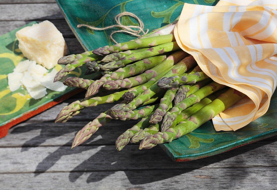 Green asparagus and Parmesan on a garden table