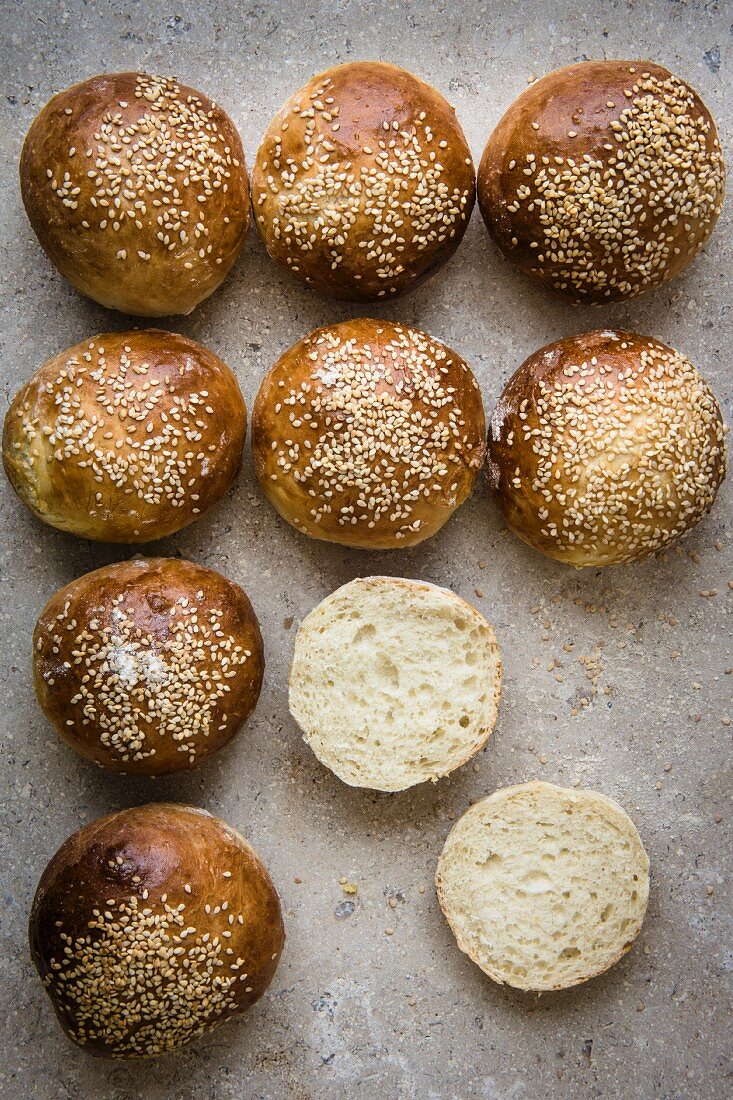 Bread rolls with sesame seeds, one halved