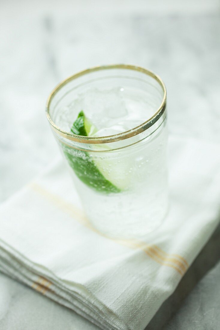 Soda water with lime and ice cubes