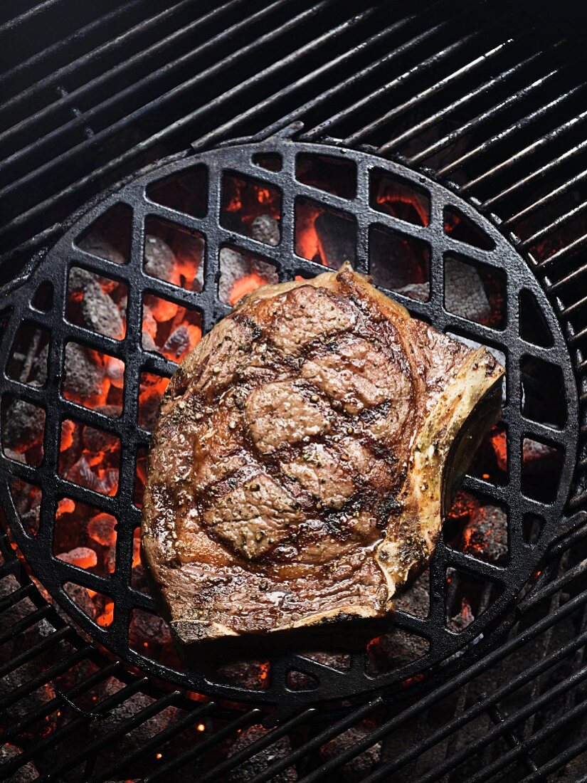 A rib-eye steak on a barbecue