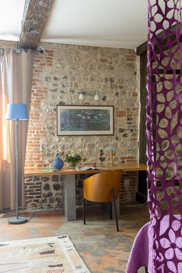 Modern desk against exposed stone wall