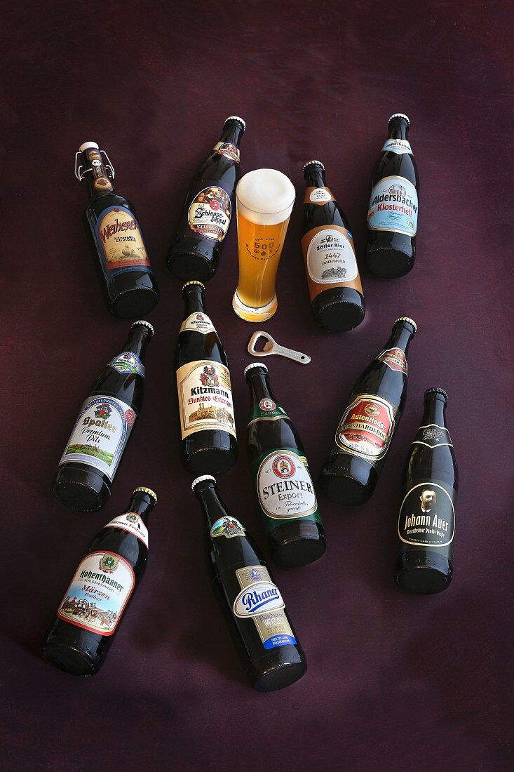 Various bottles of beer and a glass of wheat beer