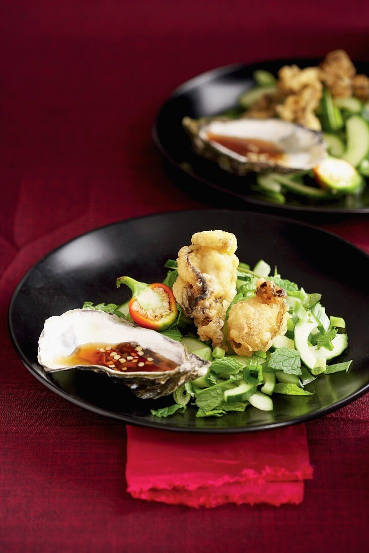 Oyster tempura with a chilli and lime dip and a cucumber and herb salad