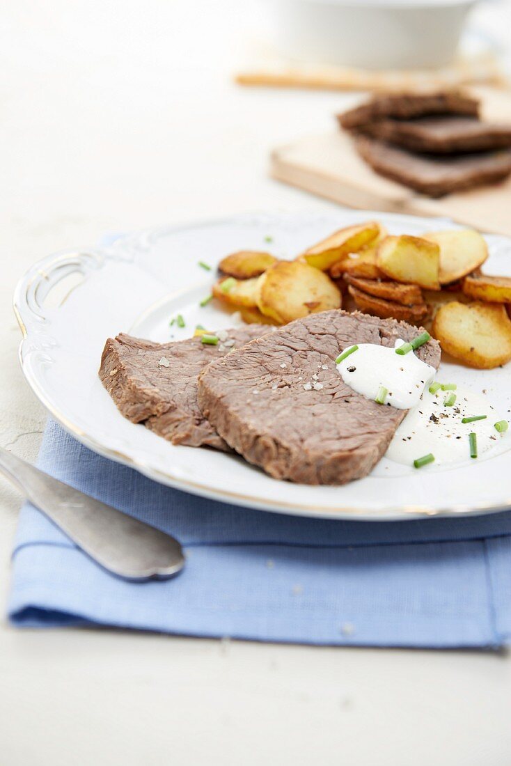 Prime boiled beef with fried potatoes and horseradish sauce