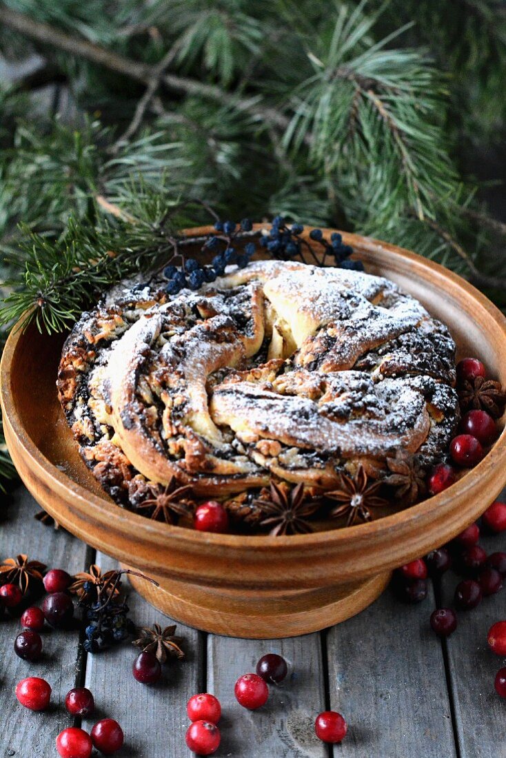 Christmas wreath cake with chocolate, cranberries and start phase