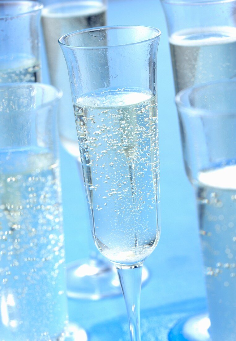 Champagne glasses on a blue surface