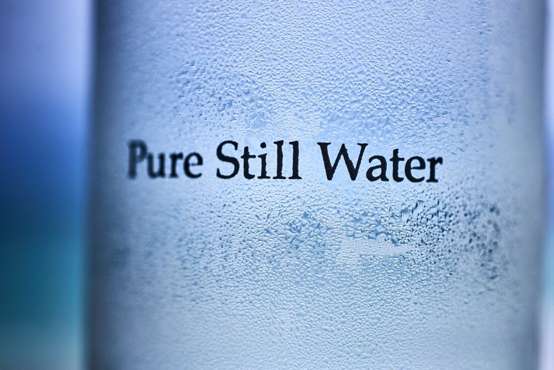 Condensation on a glass with the words 'pure still water'