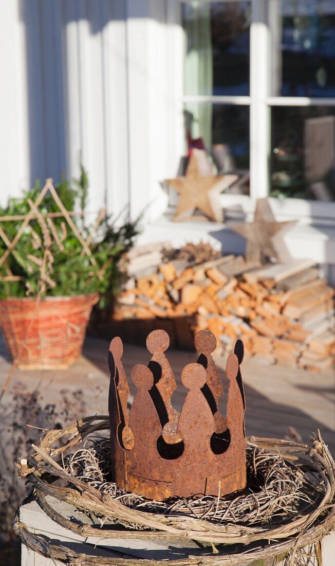 Wicker wreath and rusty crown on terrace