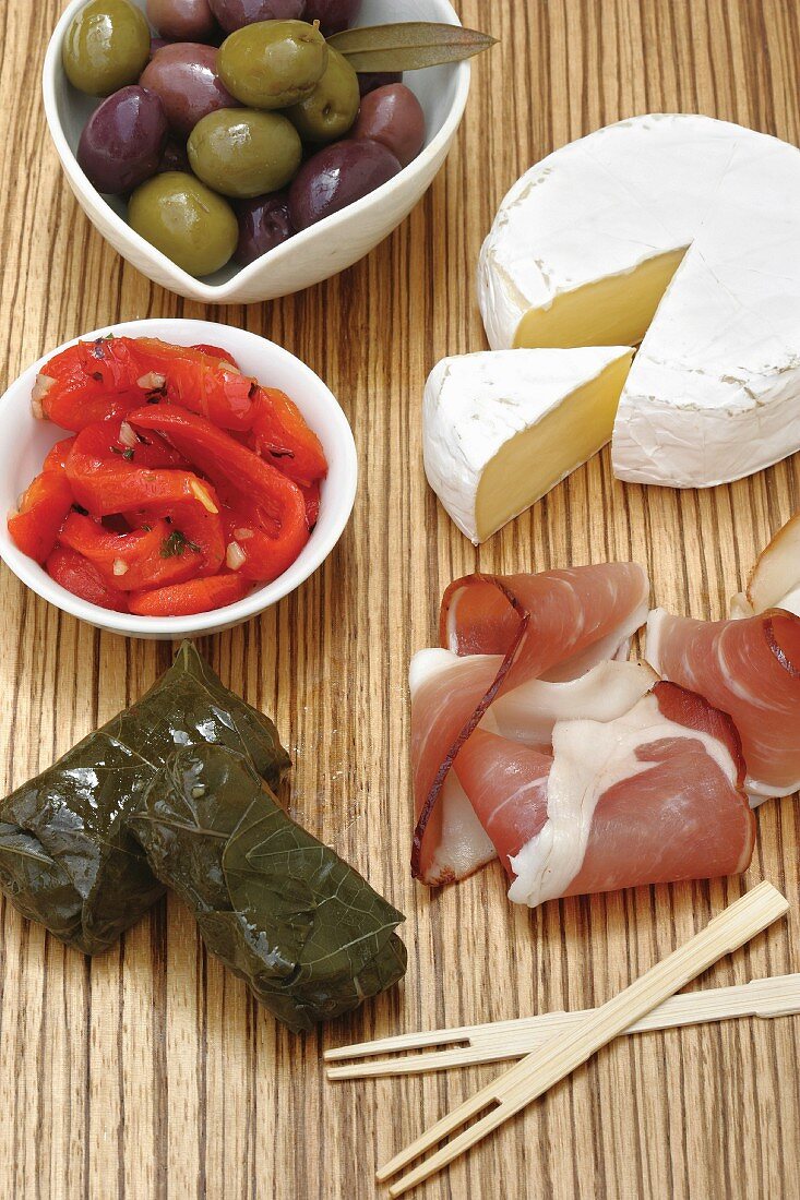 Various appetisers: olives, roasted peppers, cheese, ham and dolmades