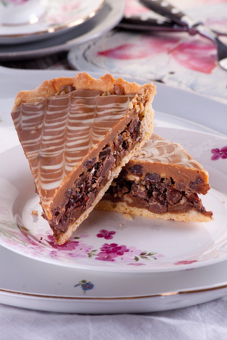 A slice of tart with dried figs, raisins, almonds and walnuts