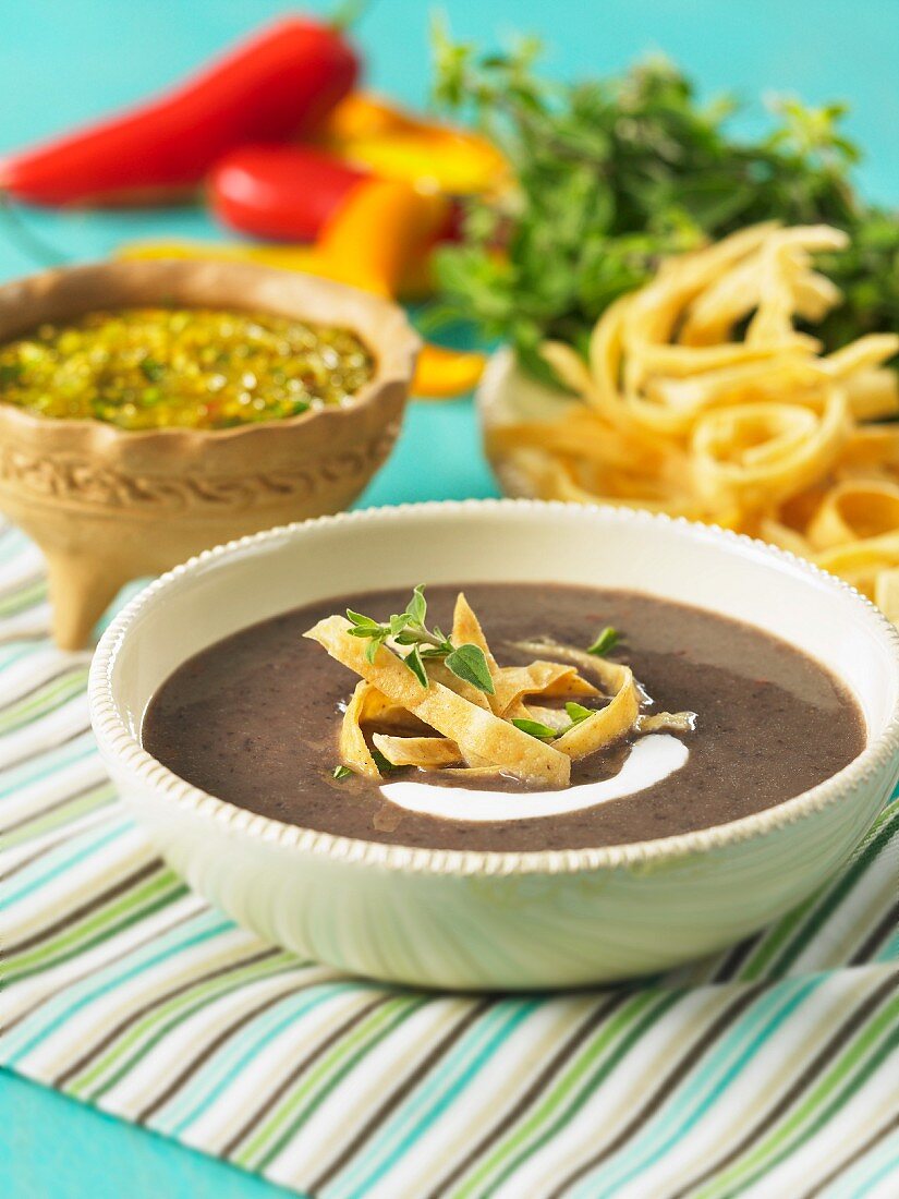 Black bean soup with tortilla strips and sour cream
