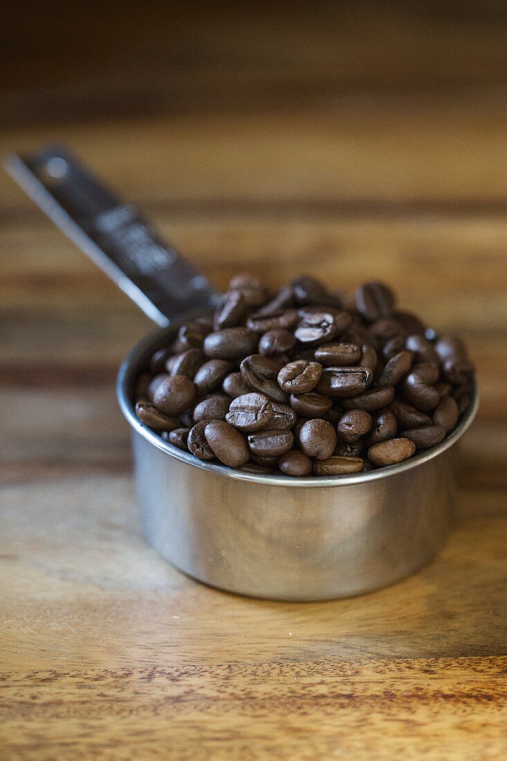 Coffee beans in a measuring cup