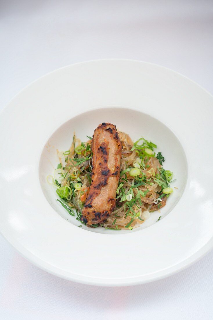 Duck sausage with glass noodles and spring onions