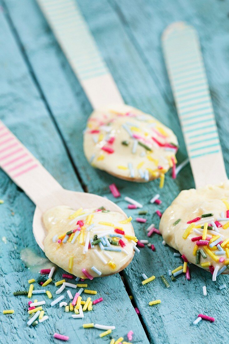 Ice cream and sugar sprinkles on striped spoons
