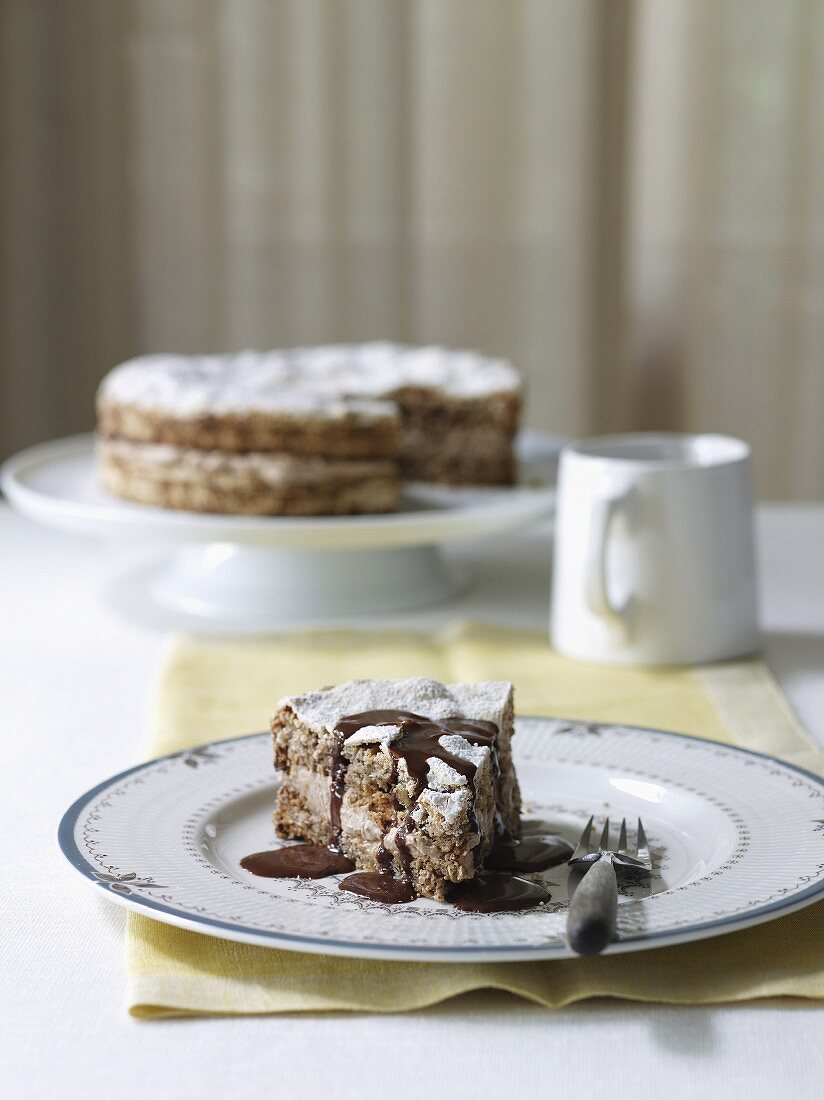 Haselnuss-Baiser-Kuchen mit Schokoladensauce