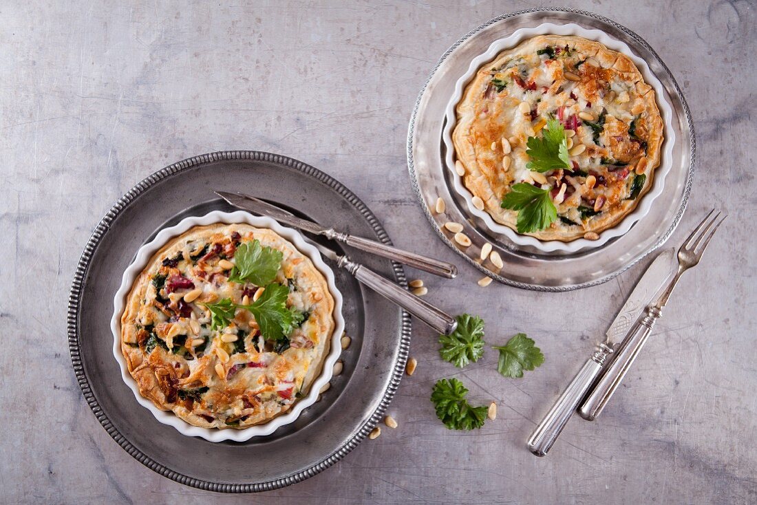 Puff pastry quiche with chard, bacon, goat's cheese and pine nuts