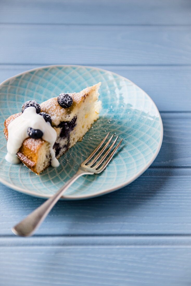 A slice of blueberry cake with yoghurt