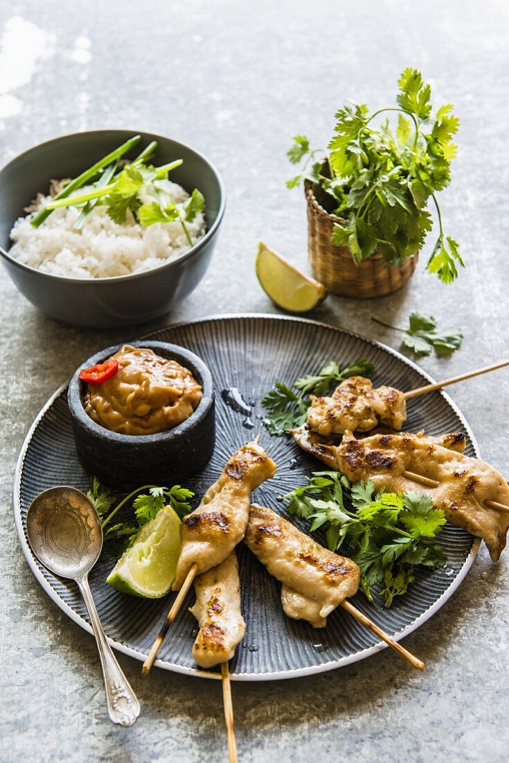 Chicken satay skewers with a peanut dip, coriander and rice (Thailand)