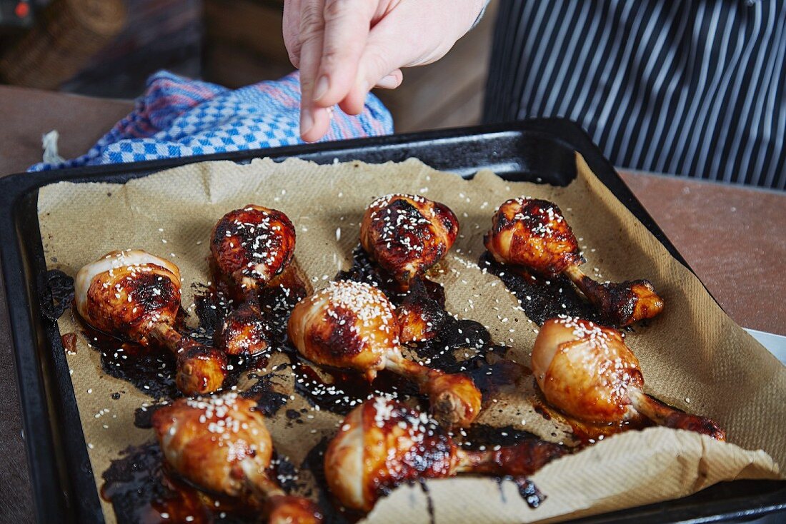 Barbecue chicken drumsticks on a baking tray