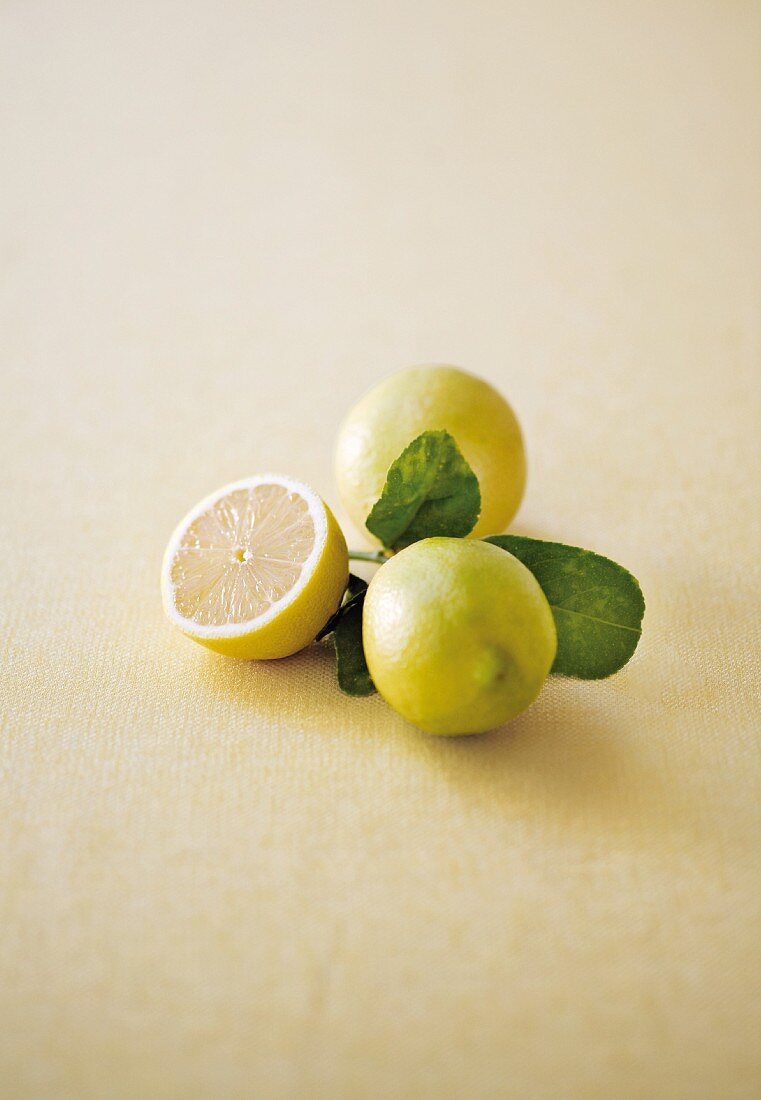 Lemons and half a lemon with leaves