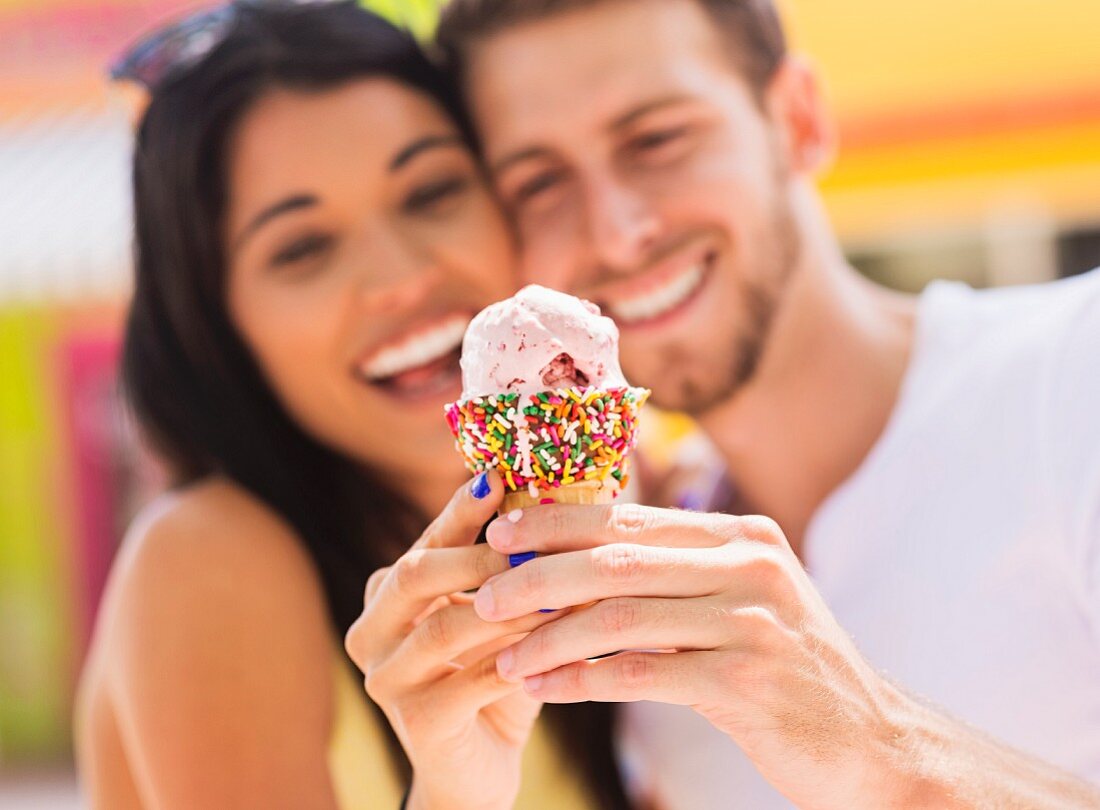 A couple sharing an ice cream cone