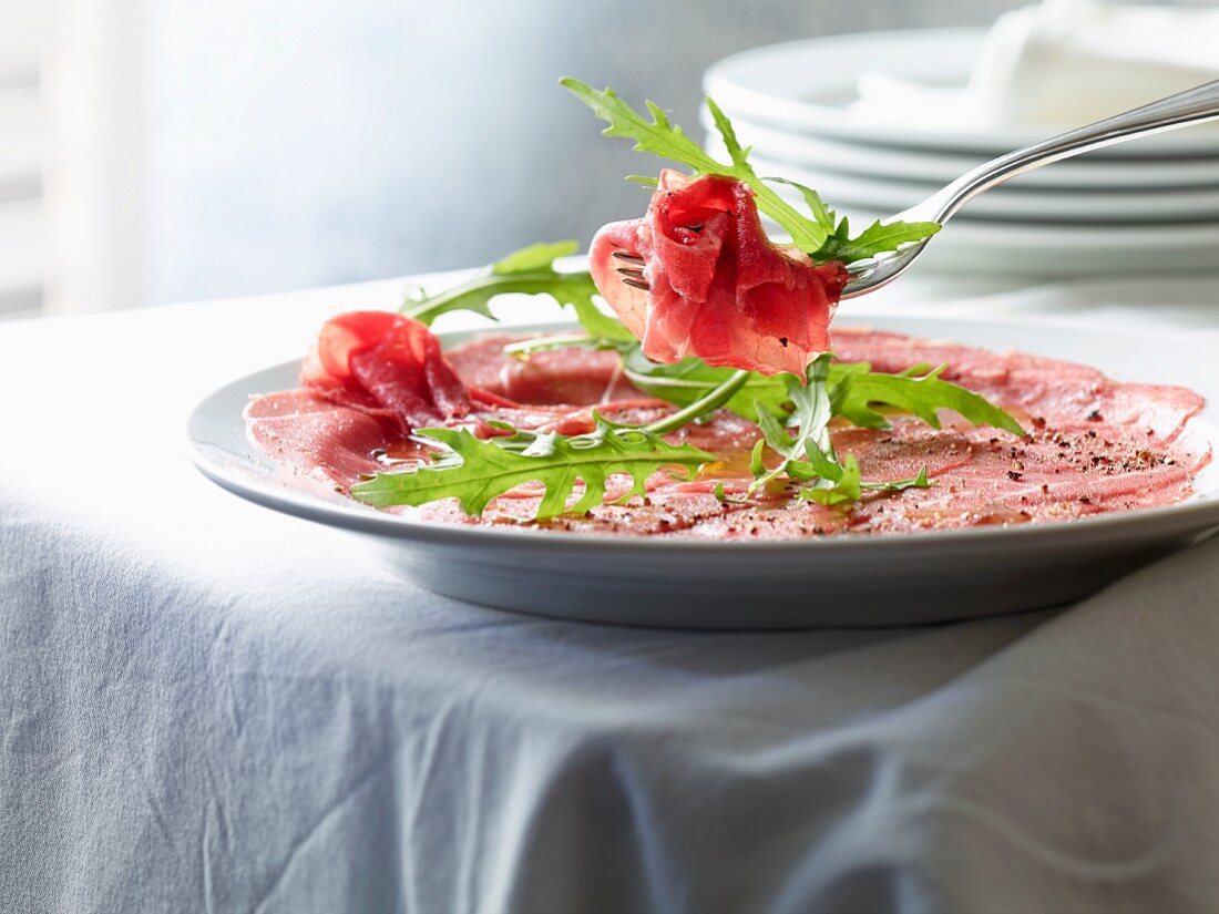 Beef carpaccio with pepper and rocket
