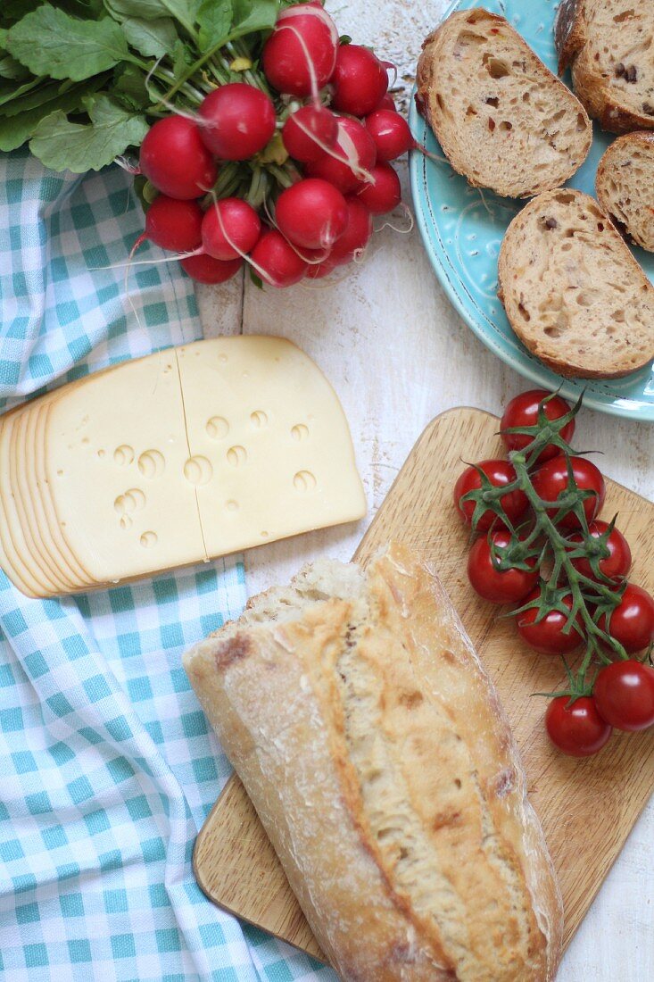 Supper with bread, cheese, radishes and tomatoes