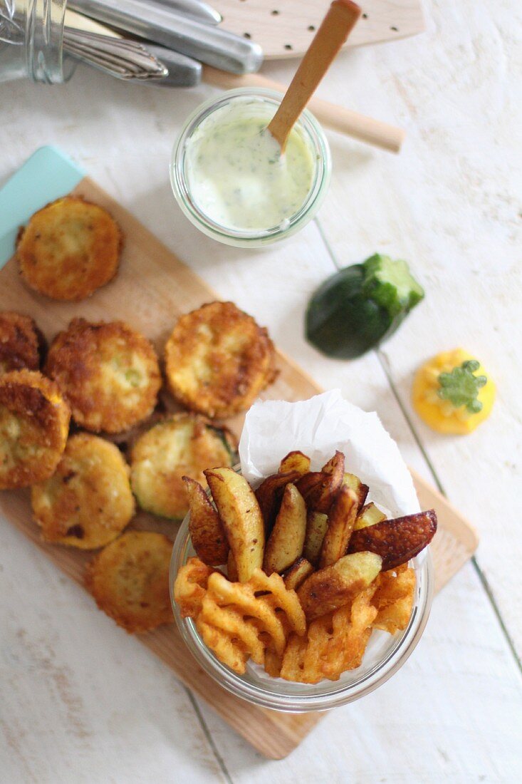 Battered courgette slices, potato wedges and lattice potatoes with a dip