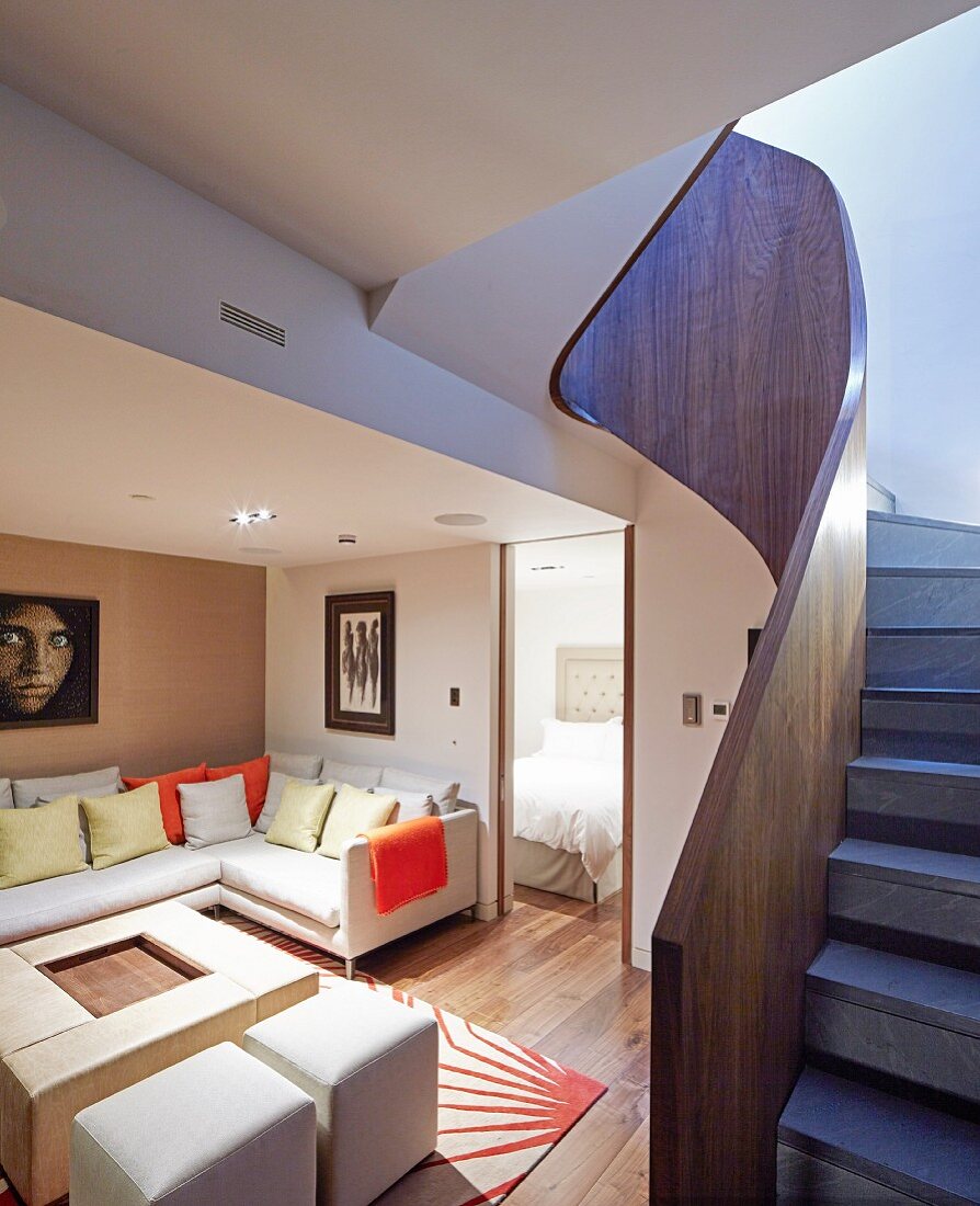 Curved staircase with solid wooden balustrade in living room