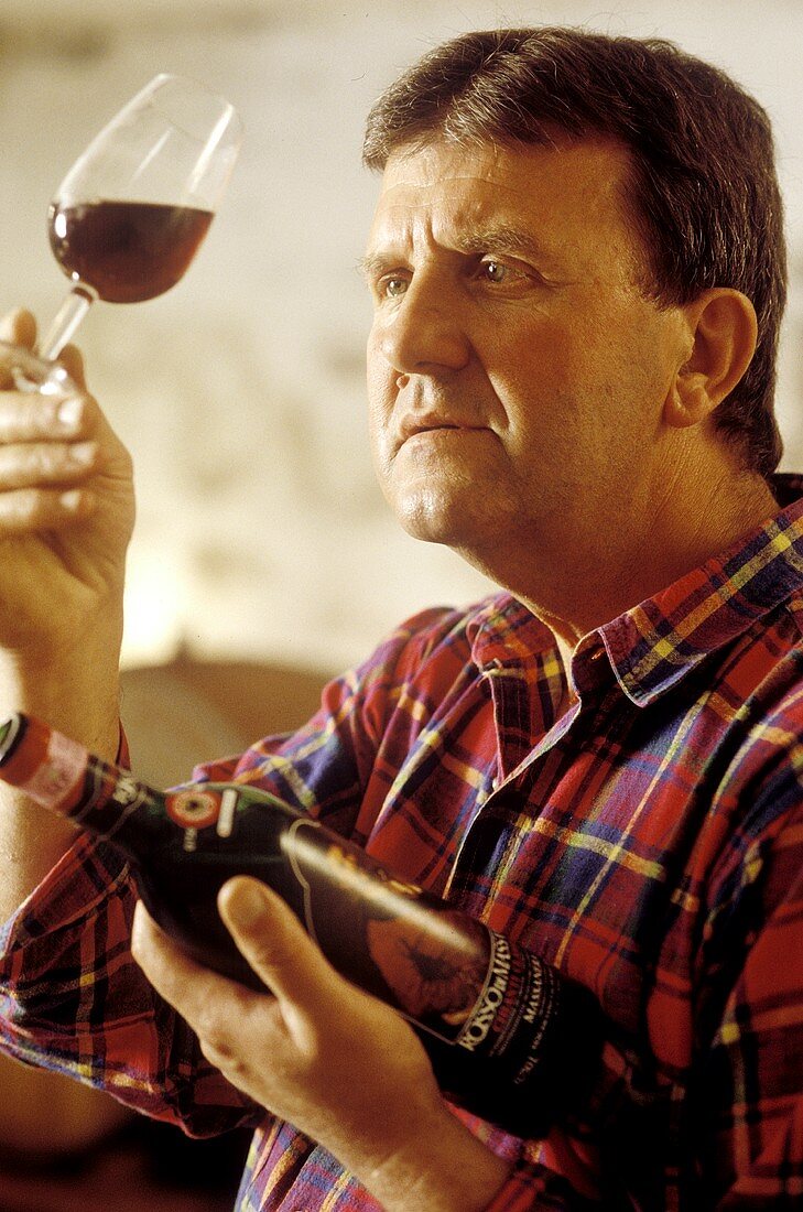 Wine grower Carlo Cataneo examining the colour of his Chianti