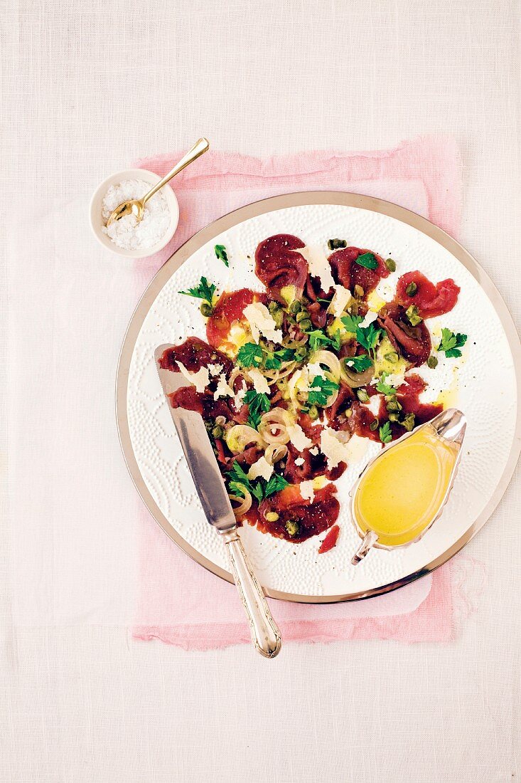 Ostrich carpaccio with parsley and capers
