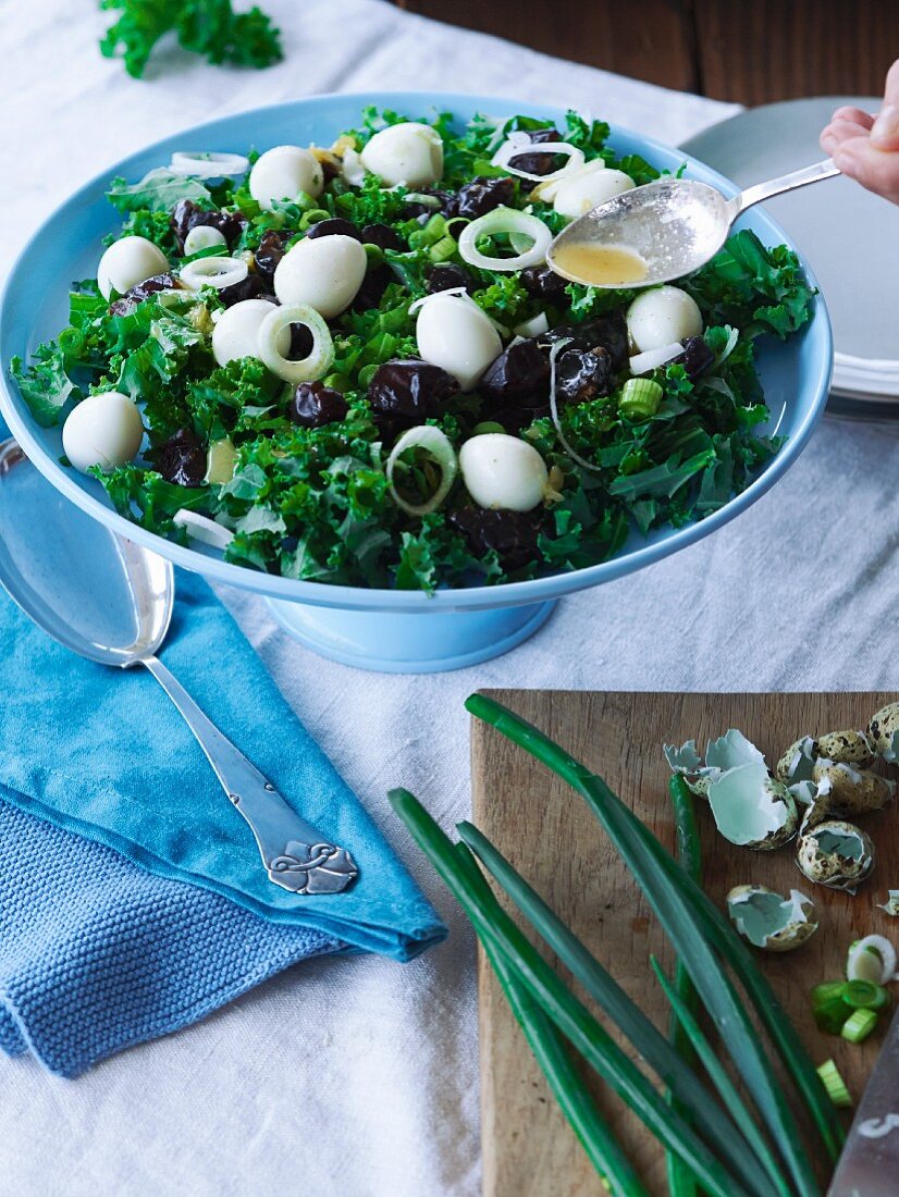 Kale salad with quail eggs and orange dressing