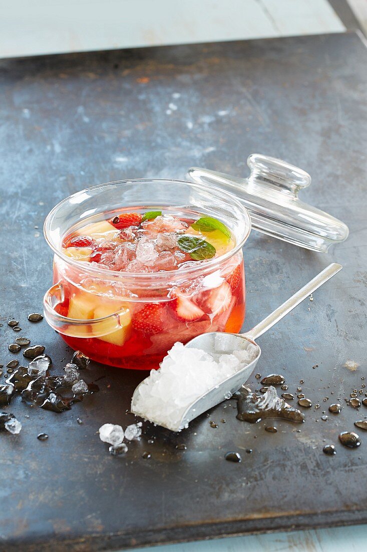 Rhubarb punch with strawberries and crushed ice