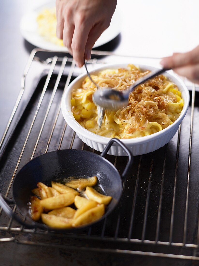 Älplermagronen (a dish from the Swiss Alps made from pasta, potatoes, cheese, cream and onions) with apple