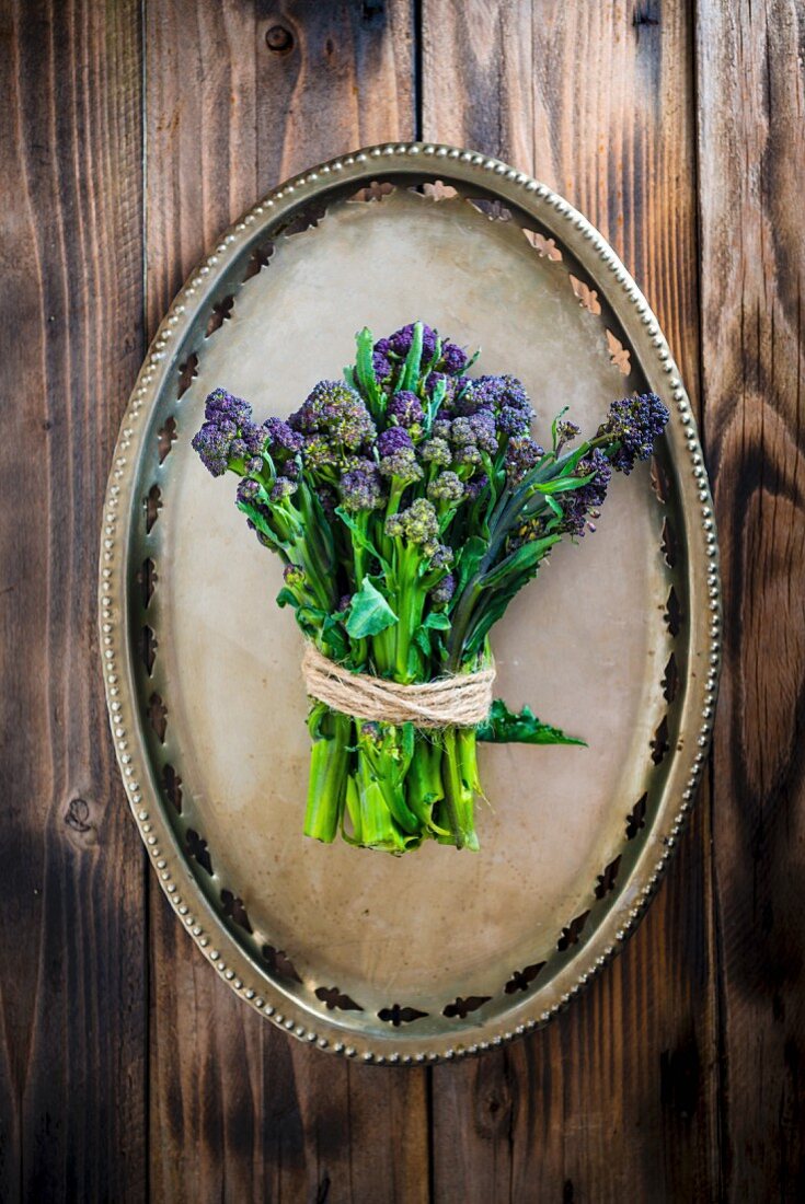 Purple sprouting broccoli on a metal plate