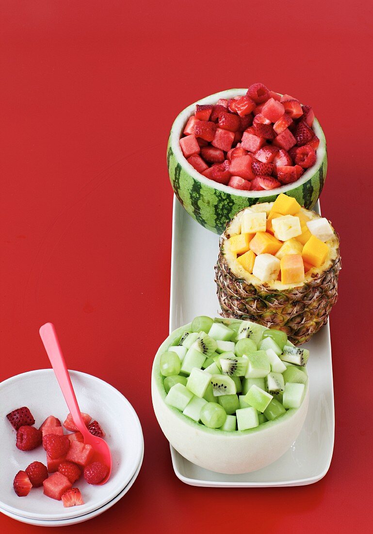 Various fruit salads served in hollowed out fruit shells