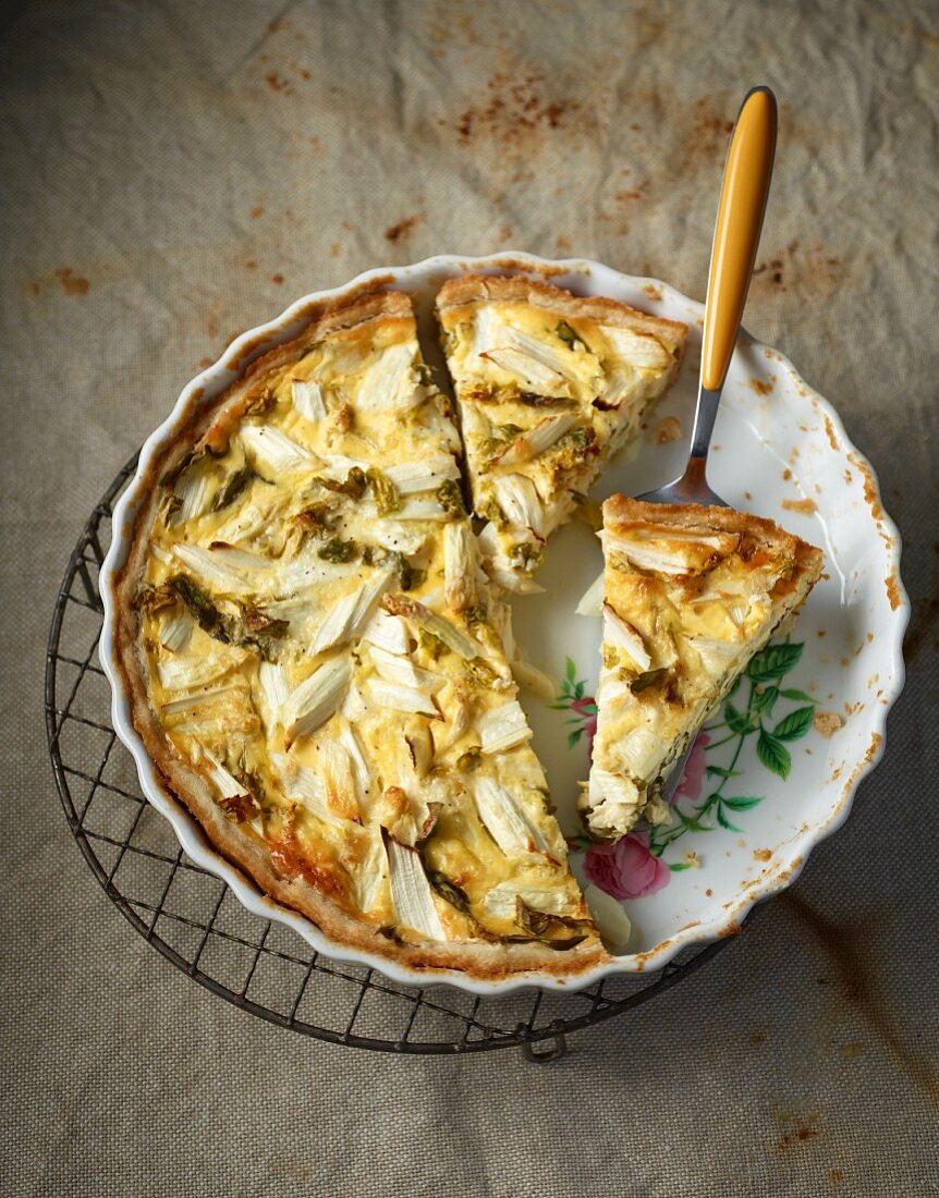 Asparagus quiche in a baking dish, sliced