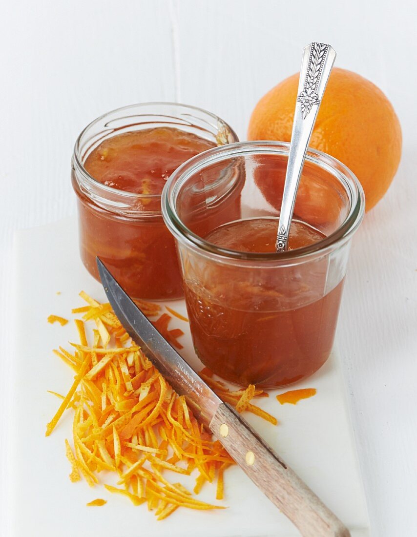 Two jars of orange marmalade with finely sliced ​​peel