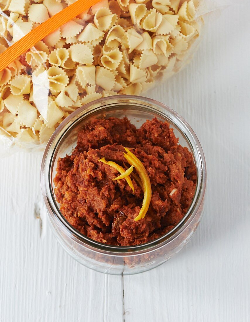 Orange pesto in a glass with raw pasta