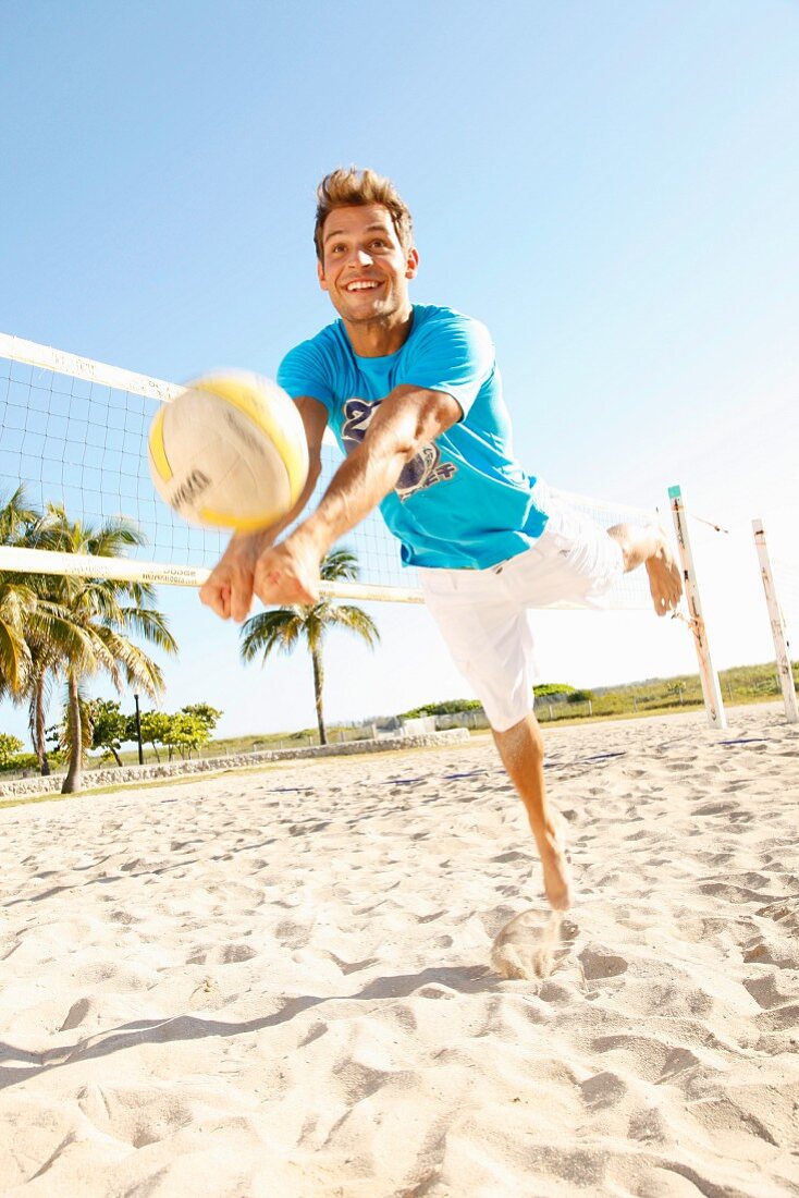 A young man with a beach volleyball