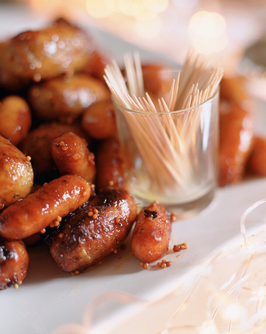 Mustard and honey-glazed cocktail sausages with toothpicks