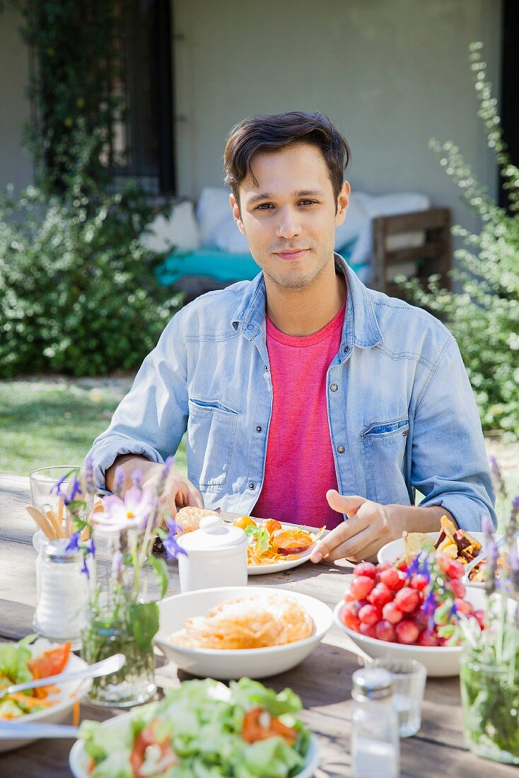 A man enjoying a meal outdoors