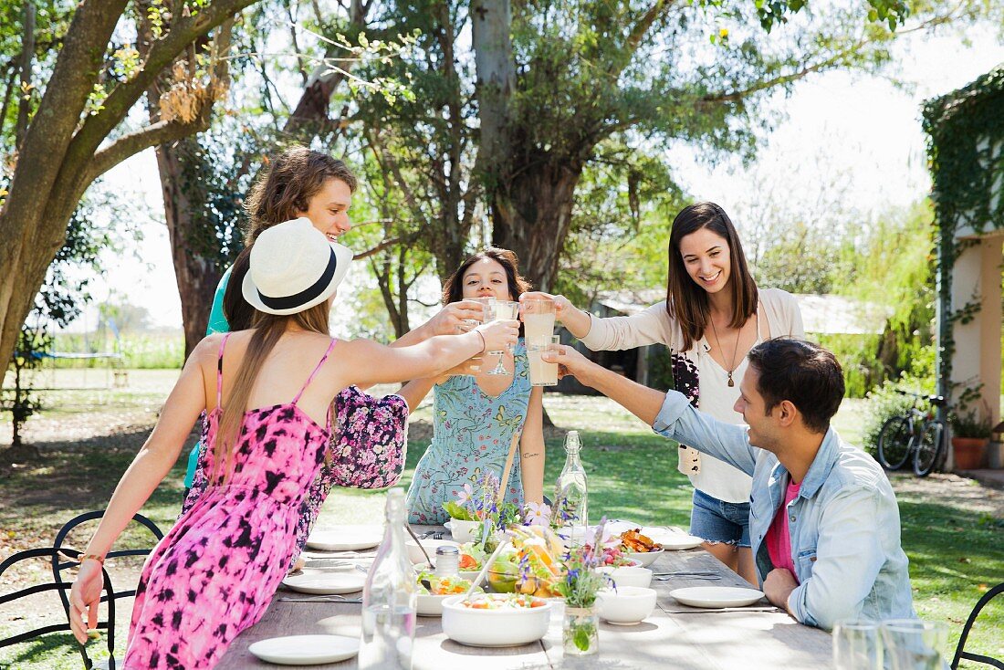 Friends eating together in a garden