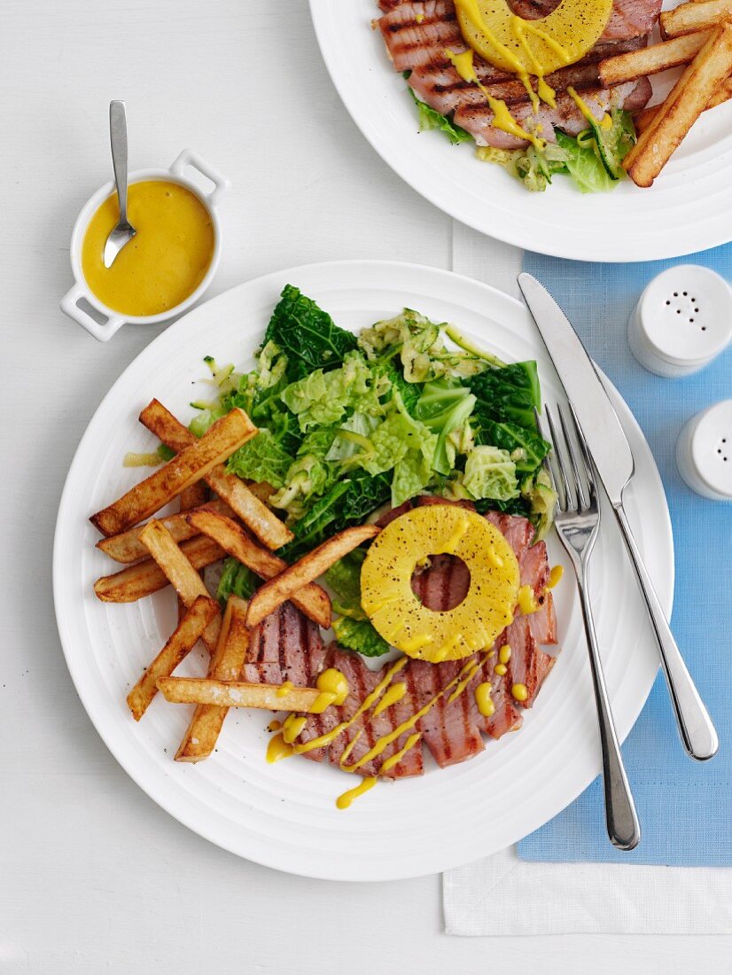 Gammon steak with pineapple, chips and vegetables